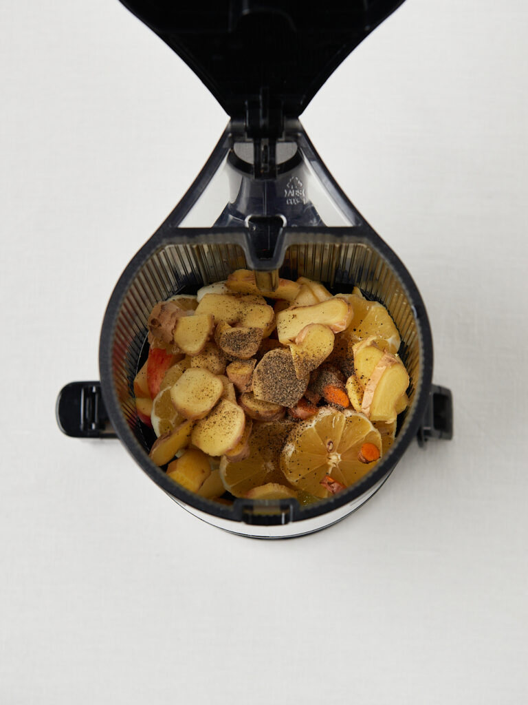 juicer with ginger apple orange phographed from above