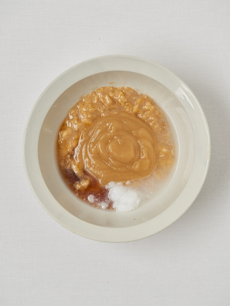 Banana bread wet ingredients mixed in a white bowl.