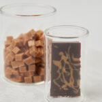 2 glass jars with chocolate bars and caramel bites