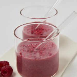 two glasses with pink smoothie