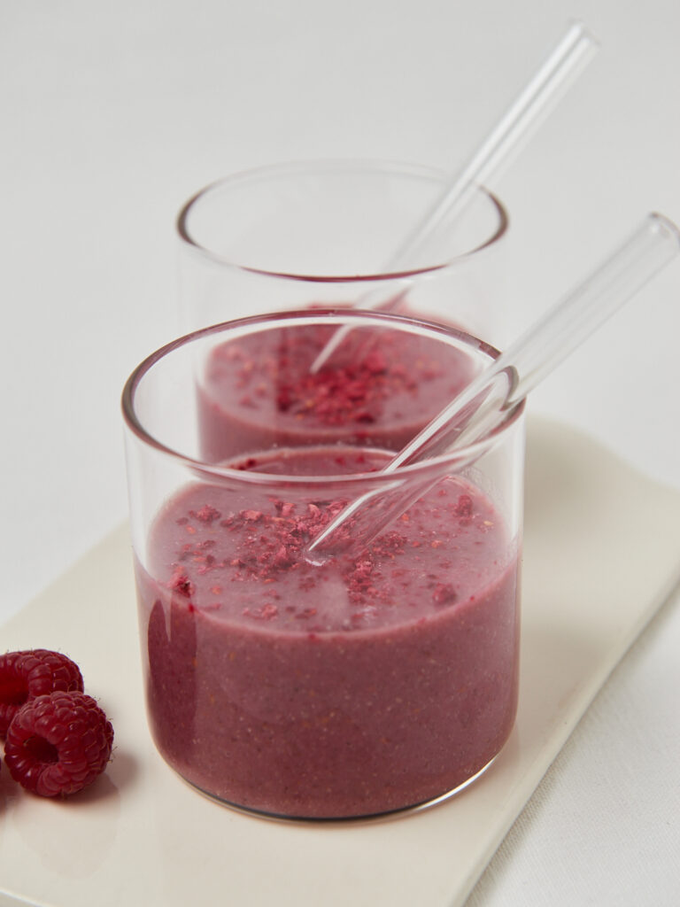 two glasses with pink smoothie