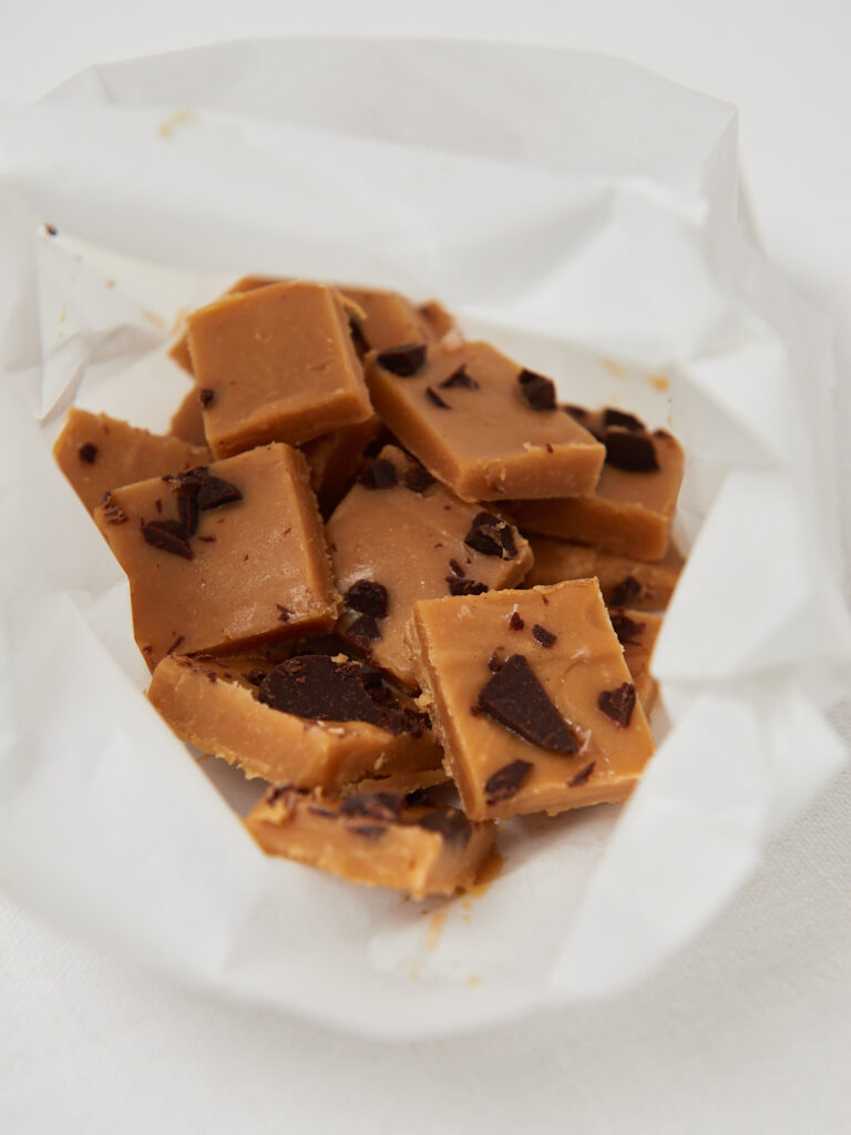 peanut butter fudge bites in a white paper bag