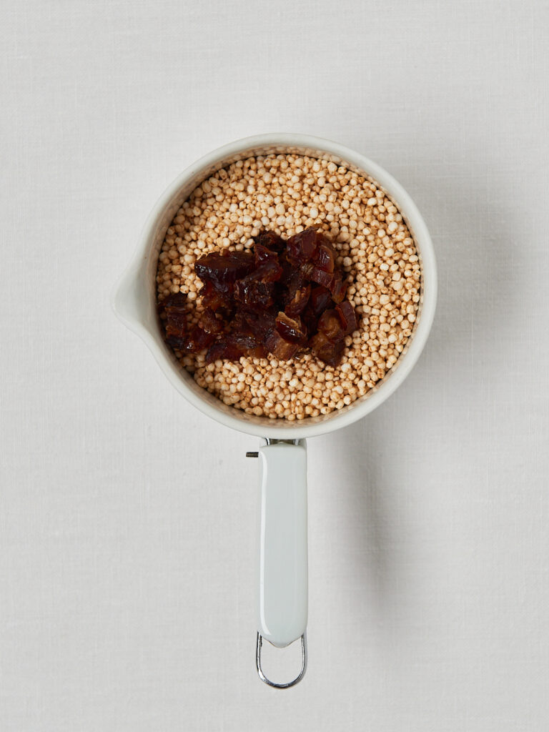 small white cup filled with quinoa chocolate and dates