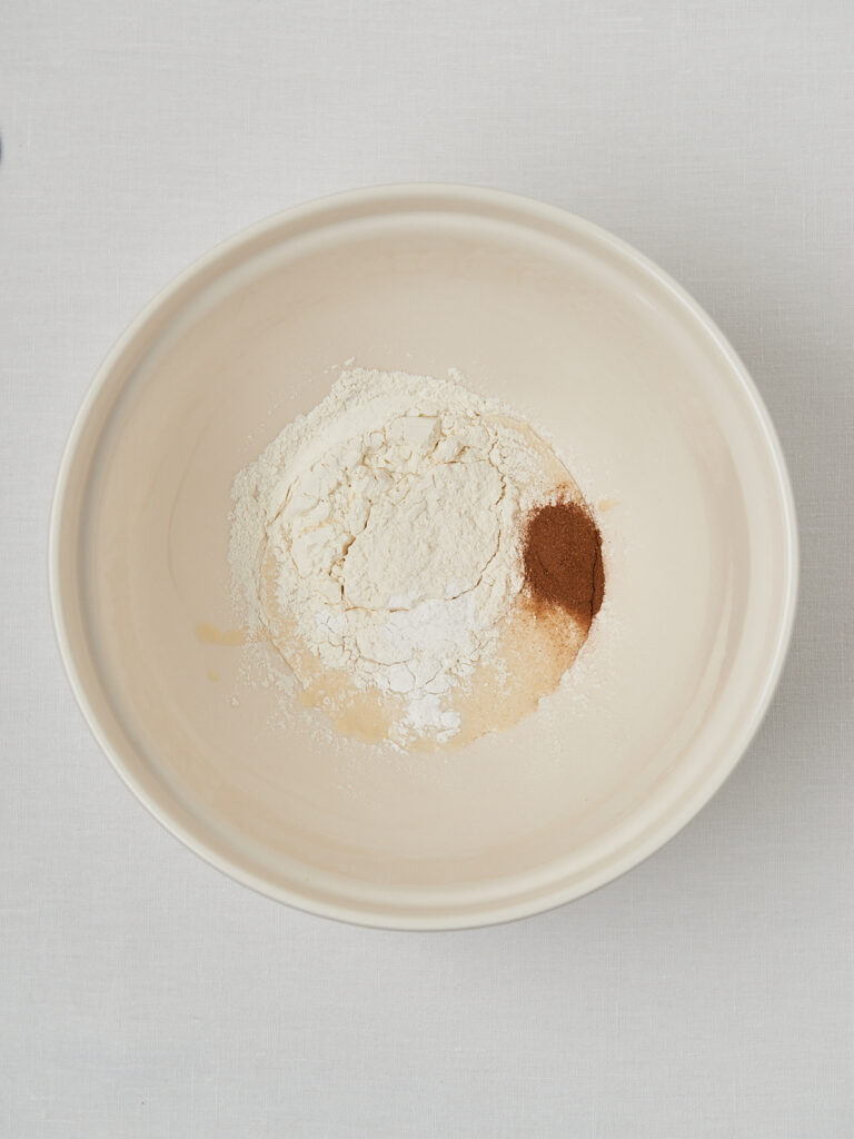 white bowls with ingredients apple sauce yogurt cinnamin sugar 