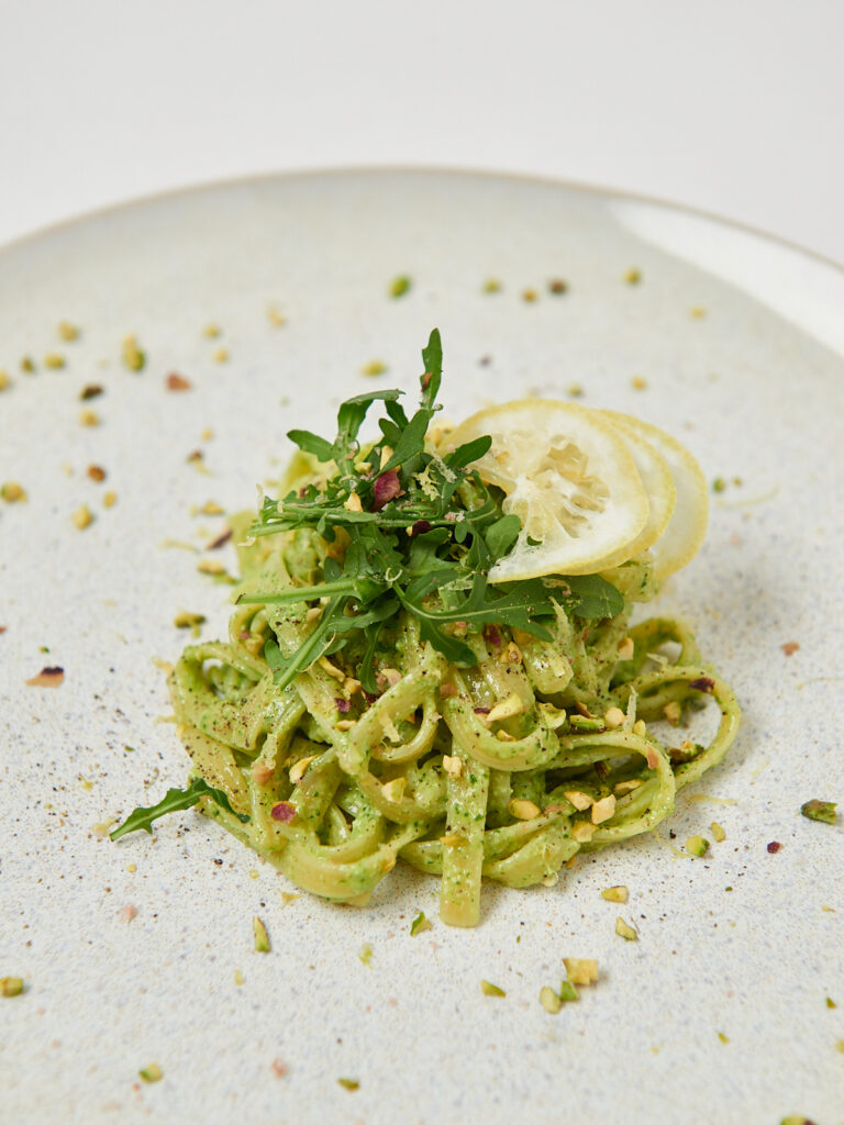 white plate pasta with pesto
