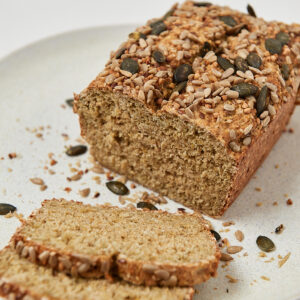 Bread made of oats and yogurt with seeds on a a white plate