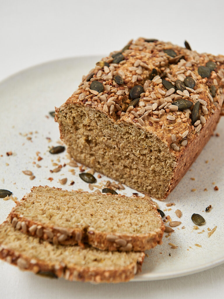 Bread made of oats and yogurt with seeds on a a white plate