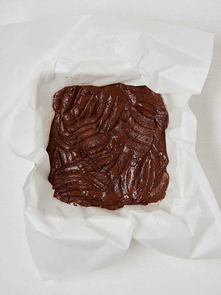 Cocoa powder and yogurt added to melted chocolate for brownie batter