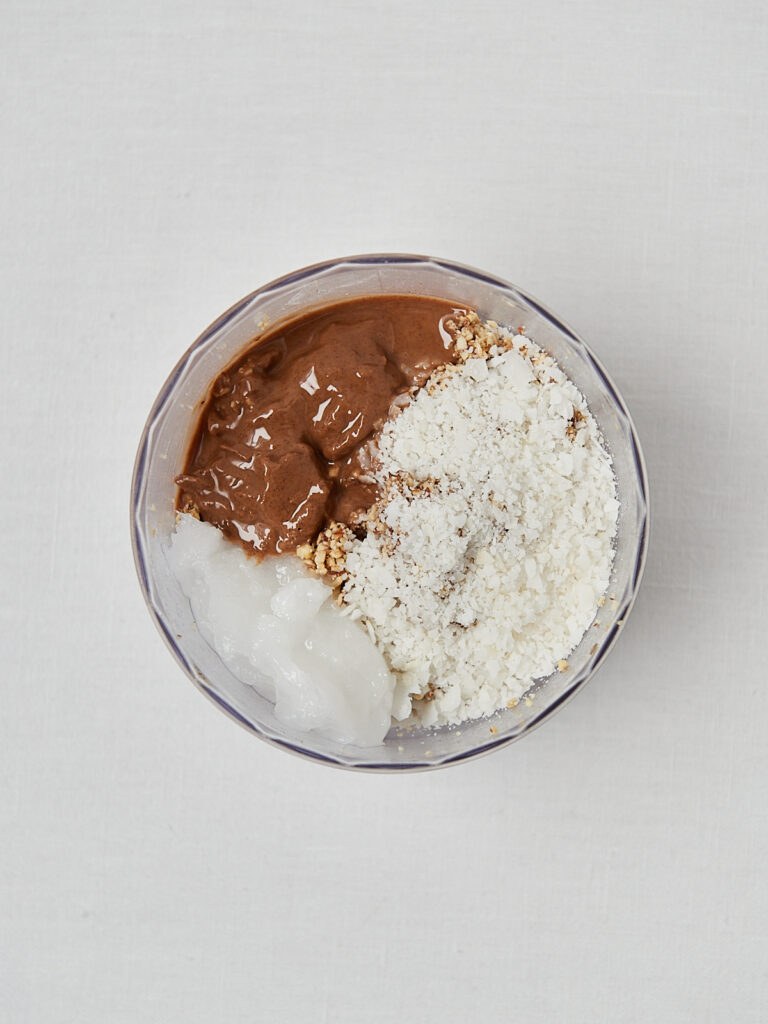 Peanut butter coconut protein mixture in blender cup