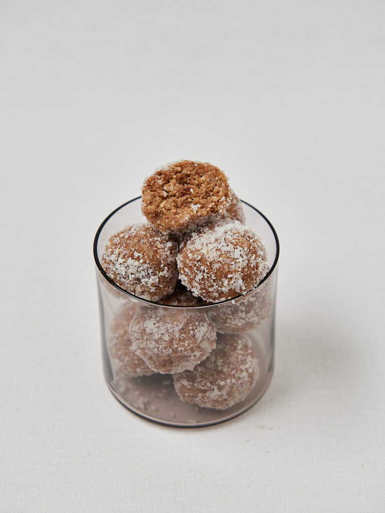 Glass filled with homemade protein balls, family friendly snack