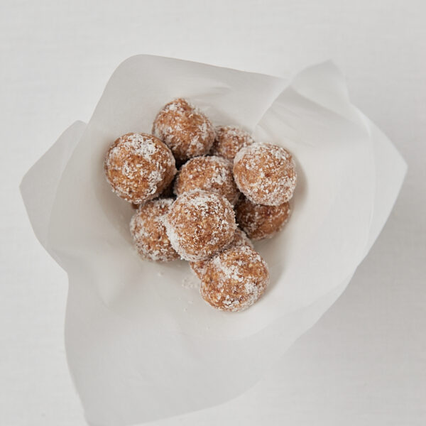 Homemade coconut protein balls wrapped in parchment paper