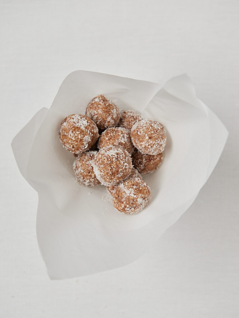 Homemade coconut protein balls wrapped in parchment paper