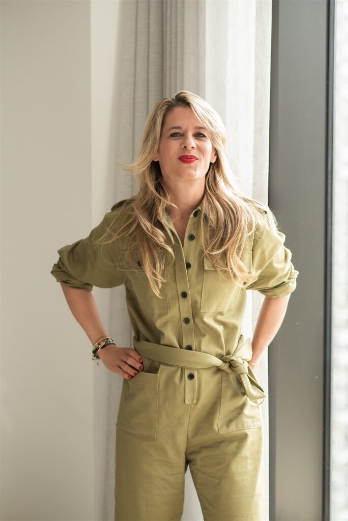 woman standing in a jumpsuit