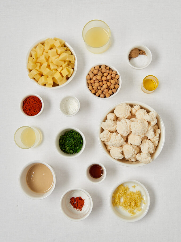 Meal prep ingredients flat lay including chickpeas vegetables spices and herbs