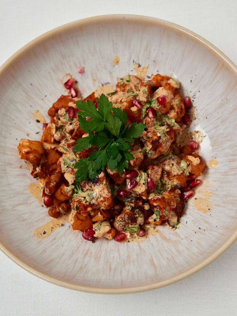 Close-up of vegan sweet potato chickpea bowl with creamy sauce