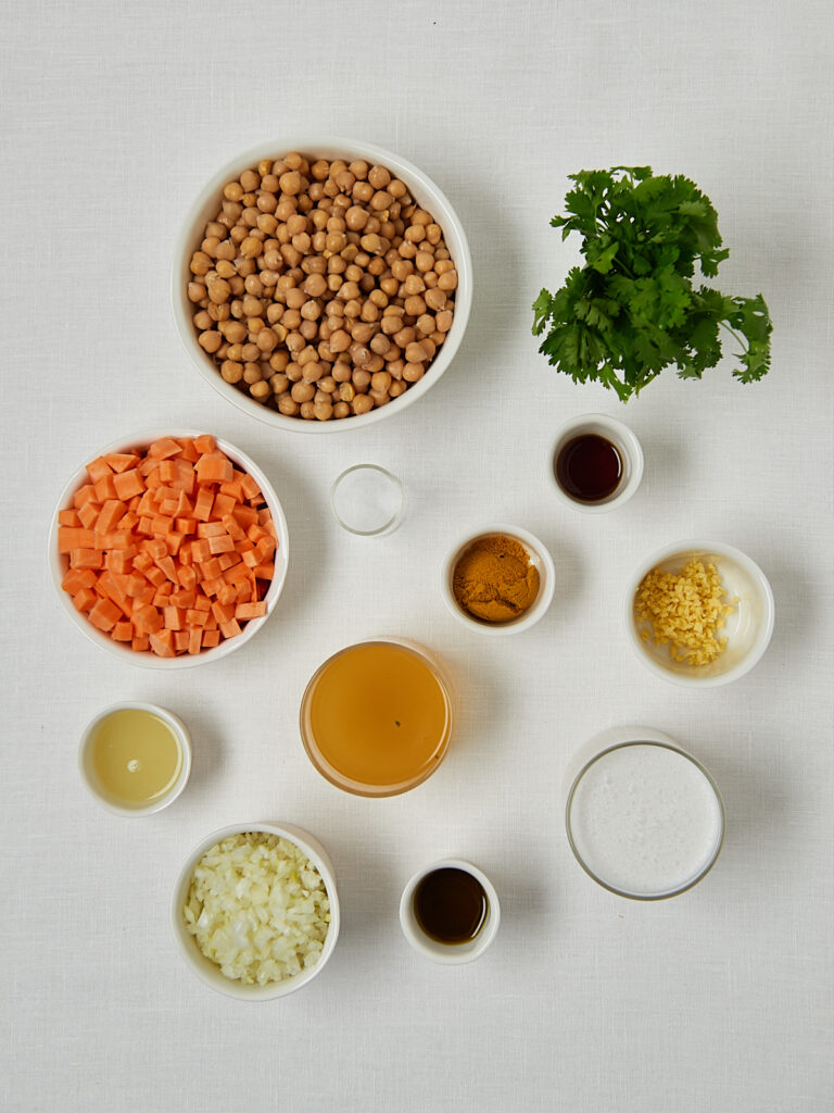 Zutaten-Flatlay Linsensuppe &ndash; rote Linsen, Kichererbsen, Koriander, Gew&uuml;rze und Ahornsirup von oben