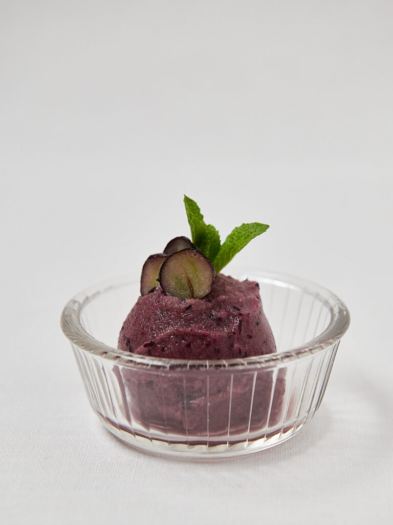 Beeren Sorbet in rundem Glassch&auml;lchen mit Blaubeeren und Minze &ndash; Draufsicht