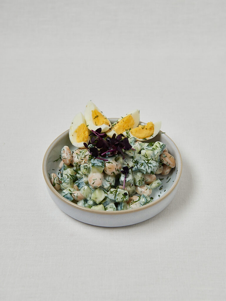 Frische Gurken Joghurt Bowl mit Ei und Dill in grauer Schüssel – Nahaufnahme seitlich
