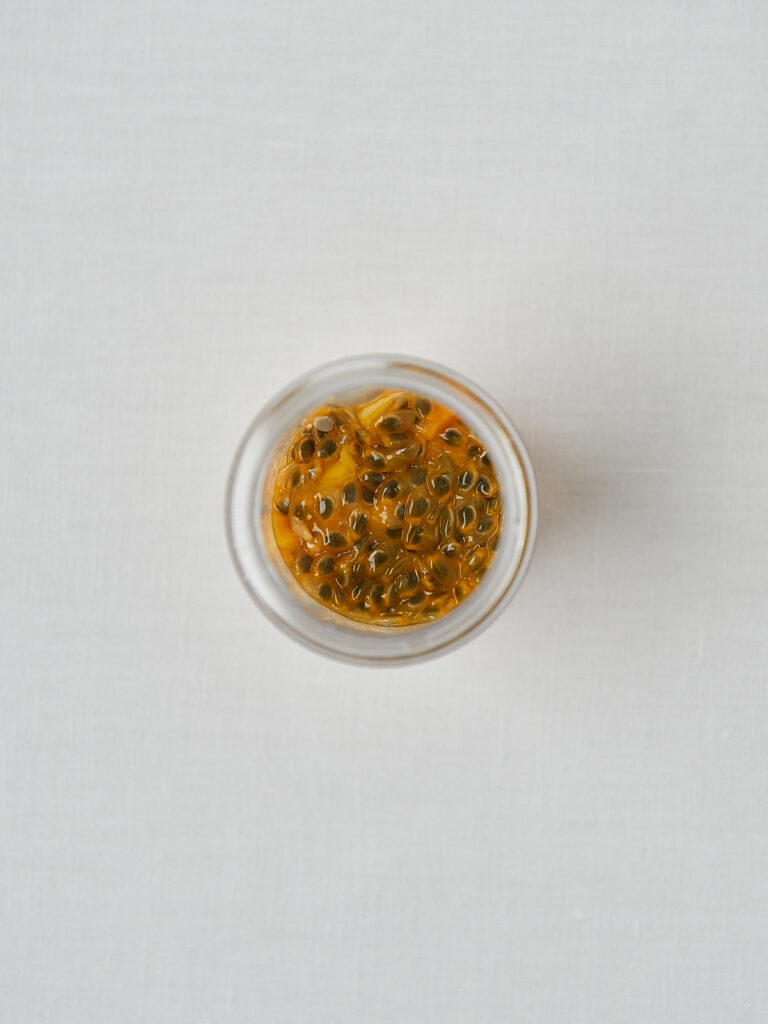 Passionsfrucht Chiasamen Topping in weißer Schüssel – Draufsicht Tropical Chia Pudding