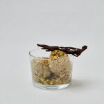 High Protein Pistachio Ice Cream in Glasschüssel mit dunklen Schokoladenstücken – gesundes Dessert