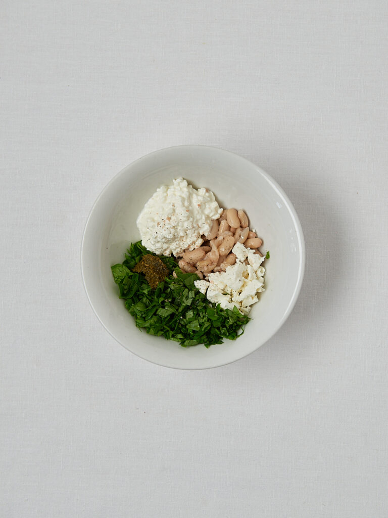 Zutaten-Flatlay High Protein Bean Pesto Wrap – Hüttenkäse, Basilikum, Feta und weiße Bohnen